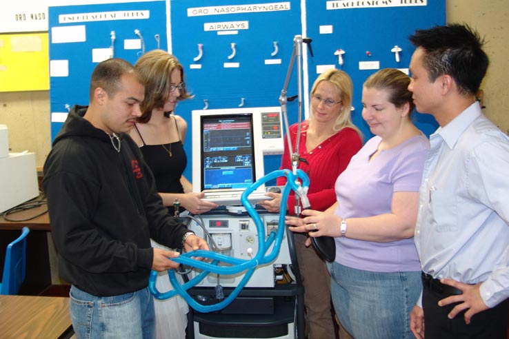 Students interacting with medical equipment